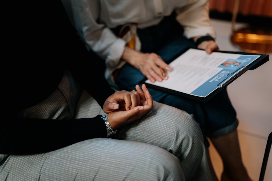 pexels-photo-5989933-5989933 Two professionals reviewing a resume in an office setting, focused on teamwork.
